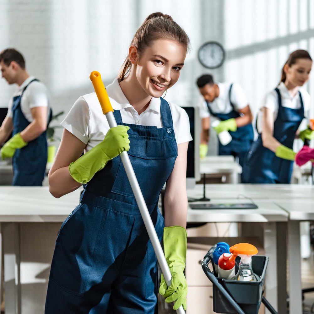 smiling-cleaner-washing-floor-and-smiling-at-camer-NBDD7QE.jpg